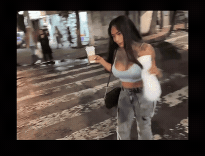Woman In Crop Top And Jeans Crossing Street GIF