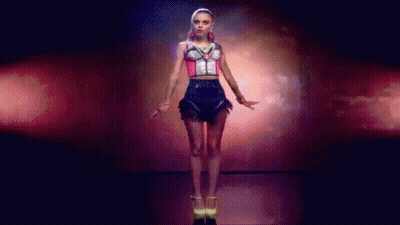 Woman In Crop Top And Skirt Dancing In Dark Room GIF