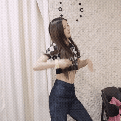 Woman In Crop Top Dancing By Brick Wall GIF