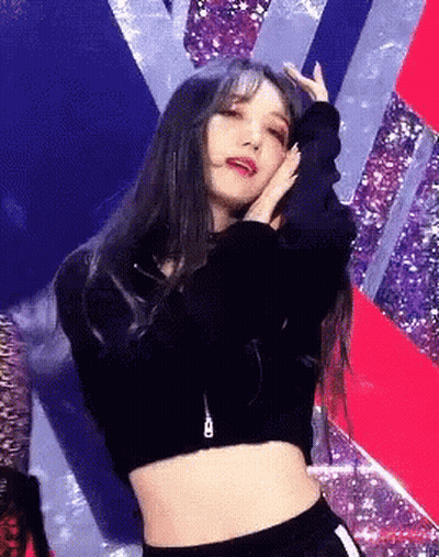 Woman in Crop Top Dancing on Stage With Hands on Head