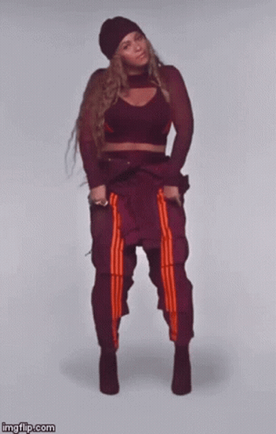 Woman In Crop Top Dancing With Crossed Legs GIF