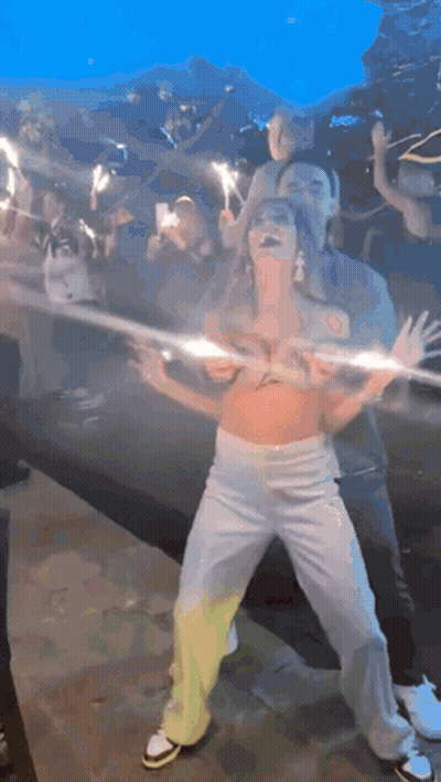 Woman In Crop Top Dancing With Sparklers GIF