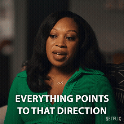 Woman In Crop Top Holding Brush Looking In Mirror GIF