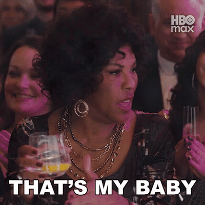 Woman In Crowd Says That's My Baby Holding Glass GIF