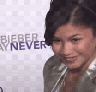 Woman In Crowd With Man In Suit And Woman With Letter C On Shirt GIF