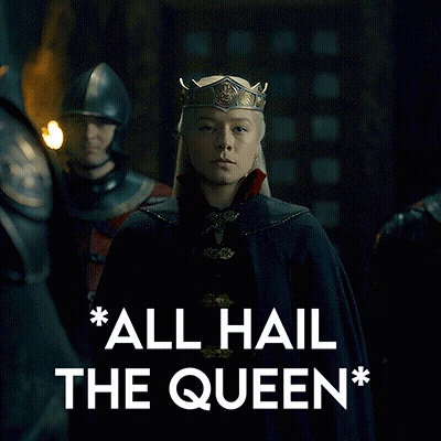 Woman In Crown Standing Next To Man In Helmet GIF