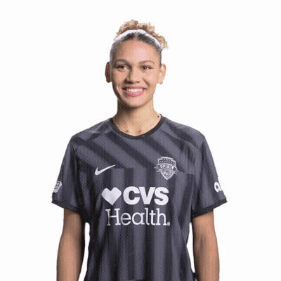 Woman In CVS Health Shirt Smiling With Hands Folded GIF