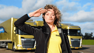 Woman In Daf Shirt Saluting In Front Of Yellow Truck GIF