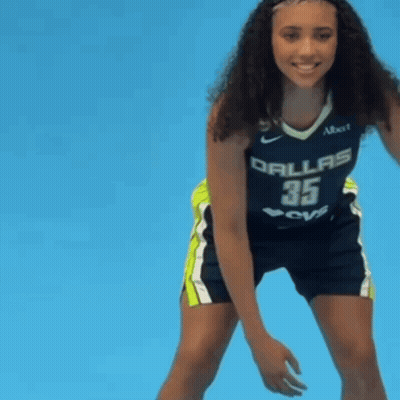 Woman In Dallas Jersey Holding Ball GIF