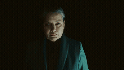 Woman In Dark Room Asking What Are You Prepared To Do For Me GIF
