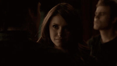 Woman In Dark Room Looking At Man GIF