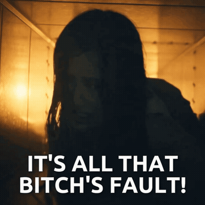 Woman In Dark Room Saying It's All That Bitch's Fault GIF