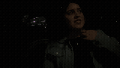 Woman In Dark Room Saying Its Funny GIF