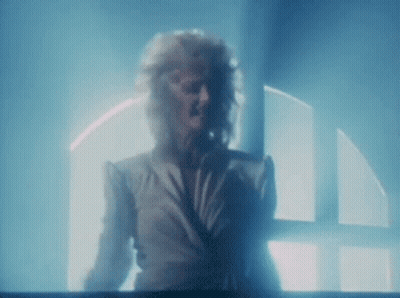 Woman In Dark Room With Blue Light From Window GIF