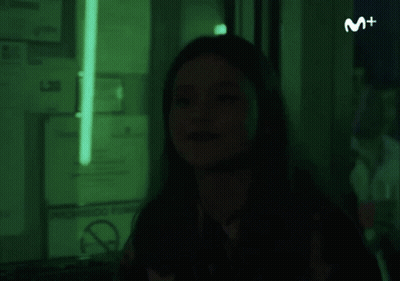 Woman In Dark Room With Green Light And No Smoking Sign GIF