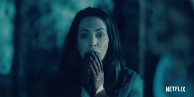 Woman In Dark Room With Netflix Logo GIF