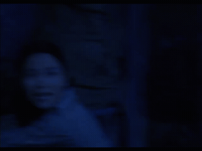 Woman In Dark Room With Ready Behind Her GIF