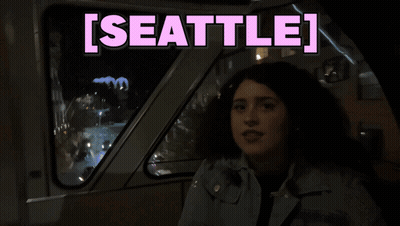 Woman In Dark Room With Seattle In Pink GIF