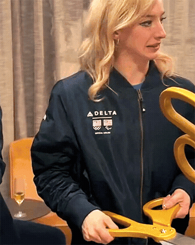 Woman In Delta Jacket Holding Scissors GIF