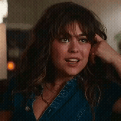 Woman In Denim Dress Holding Hair GIF