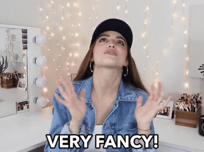 Woman In Denim Jacket And Black Hat Says Very Fancy GIF
