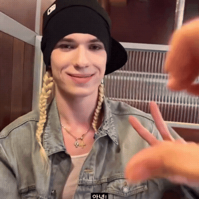 Woman In Denim Jacket And Black Hat With Letter O Making Peace Sign GIF