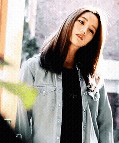 Woman In Denim Jacket And Black Shirt GIF