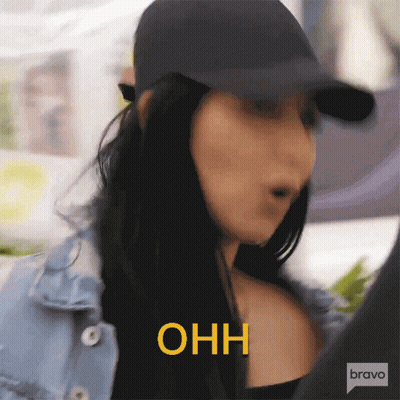 Woman In Denim Jacket And Hat Saying Ohh In Yellow GIF