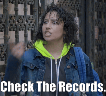 Woman In Denim Jacket And Neon Green Hoodie Says Check The Records GIF