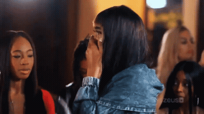 Woman In Denim Jacket Covering Face GIF