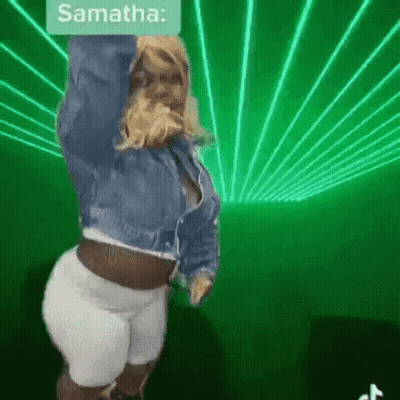 Woman In Denim Jacket Dancing Before Green Laser GIF