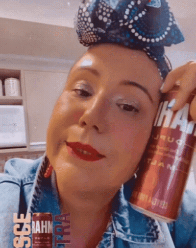 Woman In Denim Jacket Holding Can GIF