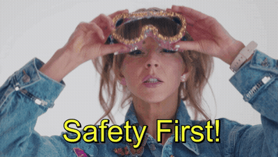 Woman In Denim Jacket Holding Goggles Saying Safety First GIF