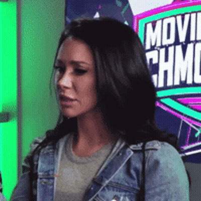 Woman In Denim Jacket In Front Of Movie Sign GIF