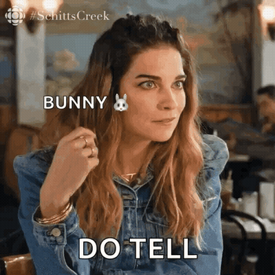 Woman In Denim Jacket Saying Do Tell GIF