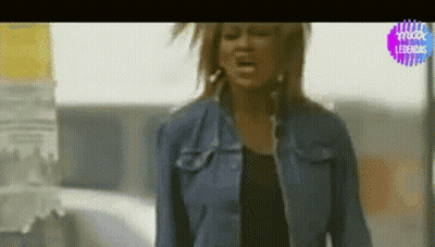 Woman In Denim Jacket Singing Into Microphone GIF