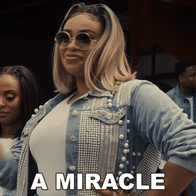 Woman In Denim Jacket With Pearls Saying Miracle GIF