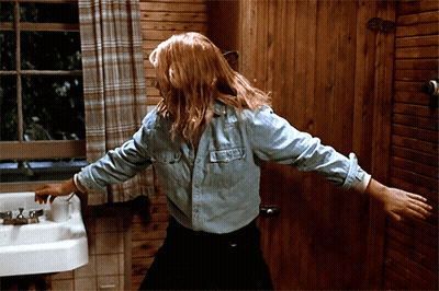 Woman In Denim Shirt At Bathroom Sink GIF