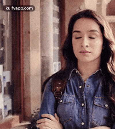 Woman In Denim Shirt With Eyes Closed GIF