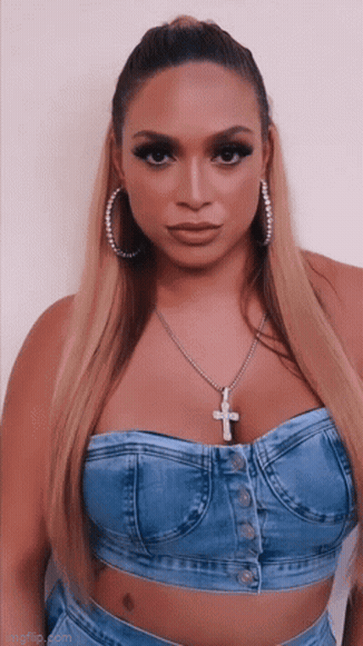 Woman In Denim Top And Cross Necklace GIF