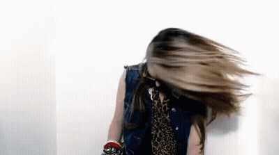 Woman In Denim Vest And Leopard Print Shirt Spinning Hair GIF