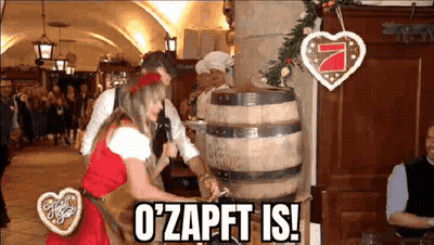 Woman In Dirndl In Front Of Oktoberfest Sign GIF