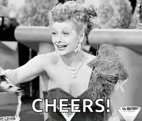 Woman In Dress Cheers With Martini GIF