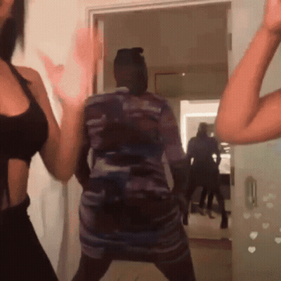 Woman In Dress Dancing In Doorway GIF