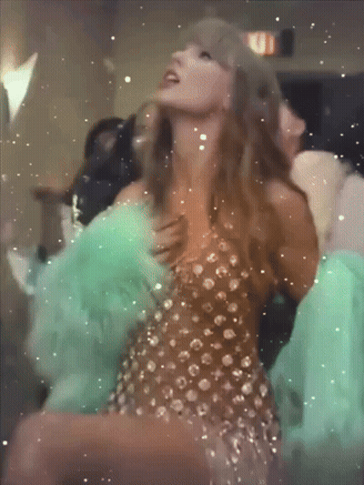 Woman In Dress Dancing With Fire Exit Sign GIF