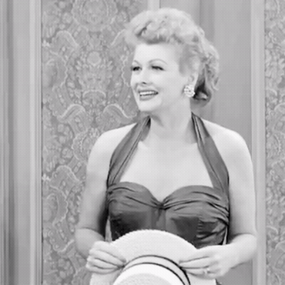 Woman In Dress Holding Hat Smiling GIF