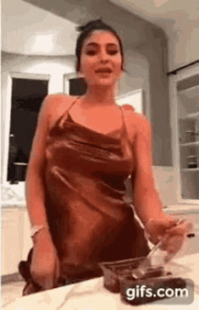 Woman In Dress Holding Spoon GIF