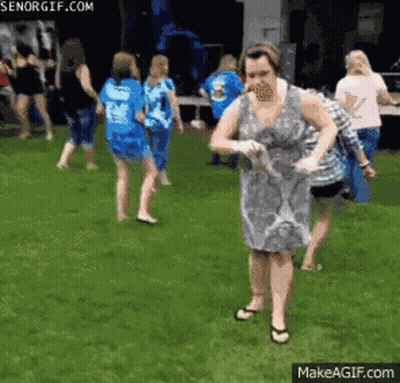 Woman In Dress In Front Of Group GIF