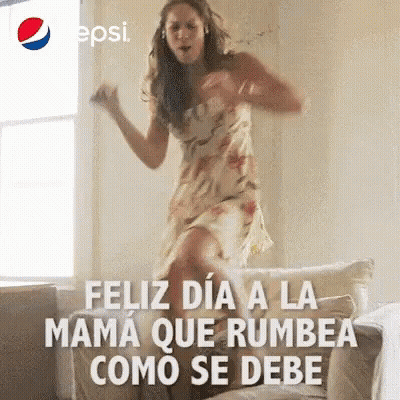 Woman In Dress Jumping And Dancing On Couch GIF