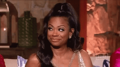 Woman In Dress Making Face On Couch GIF